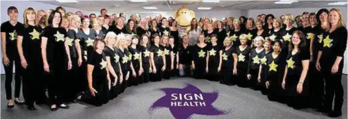  ??  ?? RECORD BID: The Rock Choir, who will be taking part in sign2sing, with Olli the monkey, who is SignHealth’s official mascot