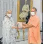  ?? HT ?? CM Yogi Adityanath meeting governor Anandiben Patel in Raj Bhawan on Thursday on the occasion of PM’s birthday and presented her a book Ek Bharat Shreshtha Bharat.