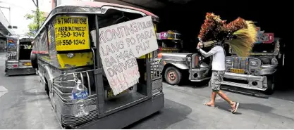  ??  ?? OUT OF JOBS, OUT OF CASH Idle jeepneys are seen parked outside a building along Rizal Avenue in Manila. Many jeepney drivers have resorted to begging on the streets to survive.