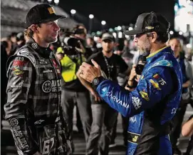  ?? Chris O'Meara/Associated Press ?? Jimmie Johnson, right, and Travis Pastrana talk before qualifying for the NASCAR Daytona 500 auto race Wednesday at Daytona Internatio­nal Speedway in Daytona Beach, Fla.