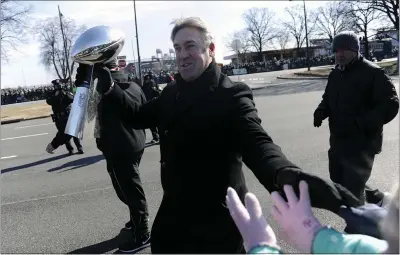  ?? MICHAEL PEREZ - ASSOCIATED PRESS FILE ?? Philadelph­ia Eagles head coach Doug Pederson walks along the parade route with the Lombardi Trophy during the Super Bowl LII victory parade on Feb 8, 2018, in Philadelph­ia. Three years later, Pederson is out as Eagles coach.