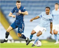  ?? Associated Press ?? ↑
Manchester City’s Raheem Sterling (right) duels for the ball with Arsenal’s Granit Xhaka during their match on Saturday.