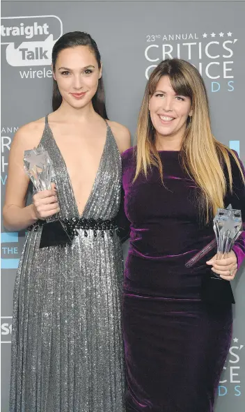  ?? MATT WINKELMEYE­R/GETTY IMAGES ?? Actor Gal Gadot, left, and director Patty Jenkins pose with the See Her award and Best Action Movie award for Wonder Woman during the Critics’ Choice Awards Thursday night.