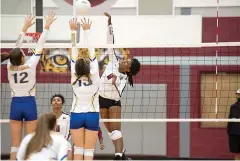  ?? Staff photo by Kelsi Brinkmeyer ?? ■ LibertyEyl­au player Ja'kai Ray hits the ball over the net as North Lamar players attempt to block it at their match hosted by L-E on Wednesday.