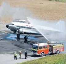  ?? Photo: BARRY HARCOURT
627337966 ?? Cooling off: The Te Anau volunteer fire brigade welcomes a DC3 as it arrives at the Te Anau-Manapouri airport after it followed the Jean Batten flight from Britain.