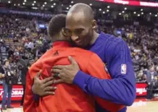  ?? CHRIS YOUNG/THE CANADIAN PRESS ?? The Lakers’ Kobe Bryant has a little meet-and-greet with the Raptors’ Kyle Lowry prior to tip off Monday night at the Air Canada Centre.