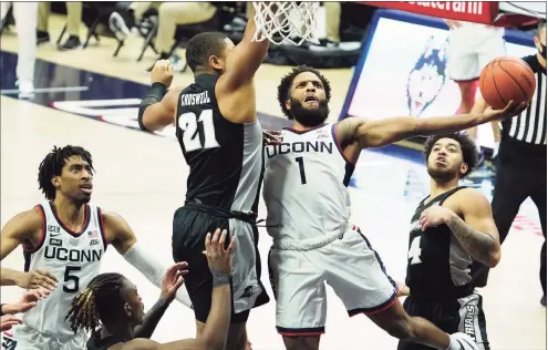  ?? David Butler II / Associated Press ?? UConn guard R.J. Cole (1) drives to the basket against Providence forward Ed Croswell (21) during the second half on Feb. 16 in Storrs.