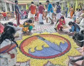  ?? PTI ?? Locals make a 'rangoli' during Onam celebratio­ns at a flood relief camp in Kochi on Saturday.