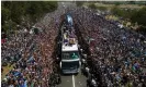  ?? AFP/Getty Images ?? Argentina’s World Cup-winning open-top bus parade is greeted by a crowd of millions in Buenos Aires. Photograph: Tomás Cuesta/