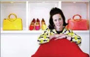  ?? BEBETO MATTHEWS, FILE - THE ASSOCIATED PRESS ?? In this 2004 file photo, designer Kate Spade poses with handbags and shoes from her next collection in New York. Law enforcemen­t officials say Tuesday that New York fashion designer Kate Spade has been found dead in her apartment in an apparent suicide.