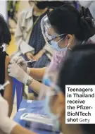  ?? Getty ?? Teenagers in Thailand receive the PfizerBioN­Tech shot