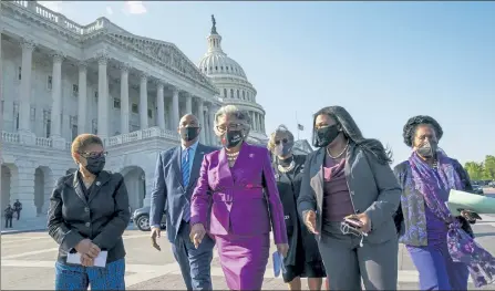  ?? J. SCOTT APPLEWHITE / AP ?? Members of the Congressio­nal Black Caucus walk to make a make a statement on the verdict in the murder trial of former Minneapoli­s police Officer Derek Chauvin in the death of George Floyd on Capitol Hill in Washington Tuesday. From left are Rep. Karen Bass, D-Calif., Rep. Andre Carson, D-Ind. Rep. Joyce Beatty, D-Ohio, chair of the Congressio­nal Black Caucus, Rep. Brenda Lawrence, D-Mich., Rep. Cori Bush, D-Mo., and Rep. Sheila Jackson Lee, D-Texas.