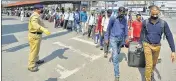  ?? PTI ?? Passengers stand in a queue as they arrive at West Bengal’s Howrah station to board a train for Delhi on Tuesday.