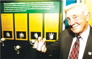  ?? AP PHOTO/ TONY DEJAK ?? Former Atlanta Braves pitcher Phil Niekro demonstrat­es how to hold a knucklebal­l on March 29, 2007, at the Great Lakes Science Center in Cleveland. Niekro, who played in the majors well into his 40s and was inducted into the National Baseball Hall of Fame in 1997, died Saturday night at the age of 81 after a lengthy bout with cancer.