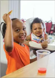  ?? WILLIAM HARVEY/RIVER VALLEY & OZARK EDITION ?? Aria Brooks, 4, left, and Maliqa Whitfield, 1, eat the free breakfast offered at the First Presbyteri­an Church in Morrilton. Sue Spivey, church member and a volunteer with the program, said 149 children and adults — a record number — were fed Tuesday....