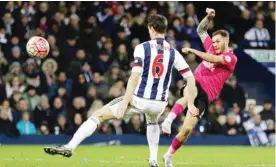  ??  ?? WEST BROMWICH: Peterborou­gh United player Jon Taylor, right, scores the second goal for his side during the English FA Cup fourth round soccer match at The Hawthorns, West Bromwich, England, yesterday. — AP