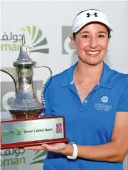  ??  ?? Lynn Casey holds her trophy after winning the women’s title