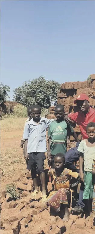  ??  ?? 0 Everson Mapayani, Malawi’s youngest councillor at 28, with some younger helpers, as