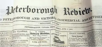  ?? CLIFFORD SKARSTEDT/EXAMINER ?? During the opening of the capsule, conservato­r Basia Baklinski pulls out two newspapers, Peterborou­gh Examiner, dated June 9, 1864, and Peterborou­gh Review, dated June 3, 1864,on Aug. 19. At the time, notes Elwood Jones, the Review was the more popular...