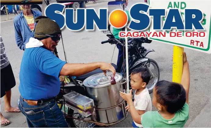  ?? (NEF LUCZON) ?? DESSERT. A vendor gives a boy taho (soy bean curd). The local street delicacy sells at P5.00 minimum to P20.00 depending on its cup sizes.