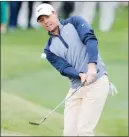  ?? The Associated Press ?? Rory McIlroy chips to the ninth green during the final round of The Players Championsh­ip, Sunday.