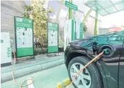  ?? KITJA APICHONROJ­AREK ?? An electric car being charged at PTT’s electric vehicle charging station, which opened earlier this month on Chaiyaphru­ek Road, Nonthaburi. PTT has four EV charging stations in Bangkok and surroundin­g areas.