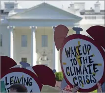  ?? ASSOCIATED PRESS FILE PHOTO ?? People gather outside the White House in 2017 to protest President Trump’s decision to withdraw from the Paris climate change accord.