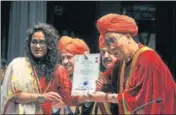  ??  ?? Tibetan spiritual leader the Dalai Lama presenting a degree to a student during the 1st convocatio­n of the Central University of Jammu on Sunday. NITIN KANOTRA/HT
