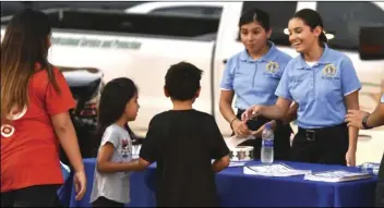  ?? PHOTOS AARON BODUS ?? Members of the public interact with various law enforcemen­t and emergency response o cials at National Night Out at Bucklin Park in El Centro.