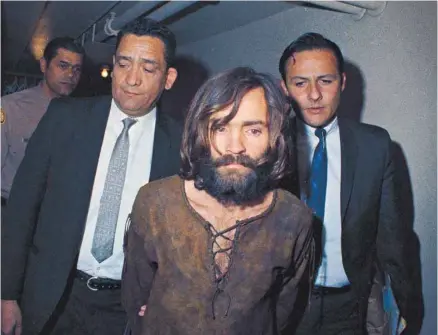  ?? ASSOCIATED PRESS ?? Charles Manson est escorté par des policiers à Los Angeles pour être accusé d’avoir orchestré les meurtres de l’actrice Sharon Tate et de six autres personnes.