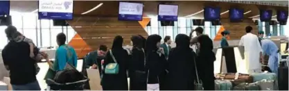  ?? — AP ?? DOHA: In this Friday, June 16, 2017 photo, Qatari and other nationals queue at the check in counters of the Hamad Internatio­nal Airport.