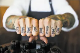  ?? Gabrielle Lurie / The Chronicle ?? Protégé pastry chef Eddie Lopez, a French Laundry alum, shows his “cake life” tattoos.