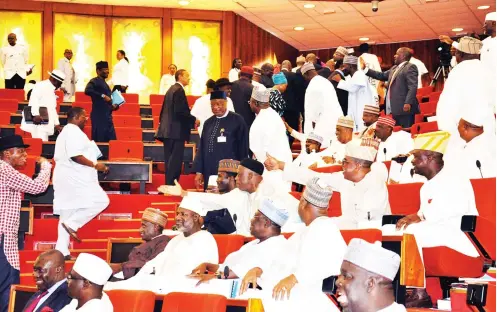  ?? Photo Macjohn Akande ?? PDP senators walk out of the Senate chambers to protest Rotimi Amaechi’s clearance as a ministeria­l nominee, before his confirmati­on at the National Assembly in Abuja yesterday.