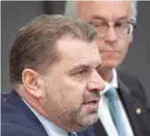  ?? — AFP ?? Ange Postecoglo­u announces his resignatio­n beside Football Federation of Australia chief David Gallop (R) in Sydney.