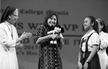  ??  ?? File photo shows Leni Robredo (centre) reacting while a pupil and Catholic nuns applaud during a forum at a Catholic-run school in Manila on March 15. — AFP photo