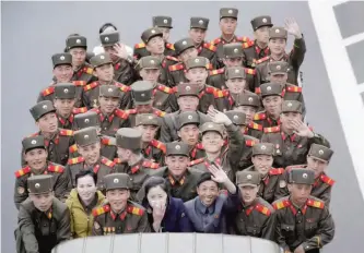  ??  ?? North Koreans sit at the back of a truck as it drives along Mirae Scientists Street yesterday in Pyongyang, which just celebrated its late leader Kim Il Sung’s 105th birth anniversar­y with a military parade. — AP