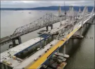  ?? JULIE JACOBSON — THE ASSOCIATED PRESS FILE ?? In this file photo, constructi­on continues on the spans of the new Governor Mario M. Cuomo Bridge, right, as vehicles make their way on the the Tappan Zee Bridge over the Hudson River, near Tarrytown, N.Y. One of the largest public infrastruc­ture...