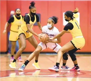  ??  ?? Archbishop Spalding’s Mariah Sanabia fights to keep ball control as she’s double-teamed by St. Frances’ Jalyn Brown and Aniya Gourdine, right, during a Thursday’s game in Severn.