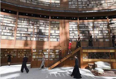  ?? — Reuters ?? Models present creations by Chanel during the fashion show at the Grand Palais turned into a giant library in Paris.