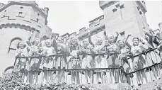  ??  ?? All smiles as schoolgirl­s find the castle a safe haven.