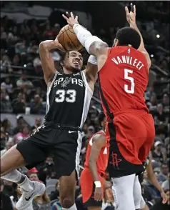  ?? Darren Abate/Associated Press ?? The Spurs’ Tre Jones goes to the basket as the Rockets’ Fred VanVleet defends Tuesday in San Antonio.