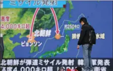  ?? AP PHOTO/SHIZUO KAMBAYASHI ?? A man stands in front of a huge screen showing TV news program reporting North Korea’s missile launch, in Tokyo on Wednesday.