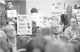  ?? Cindy Schultz / Times Union ?? Protesters make their demands known at a New York state health department drug review board in 2016 in Albany, N.Y. The group was calling for unrestrict­ed access to Medicaid treatment for people living with hepatitis C.