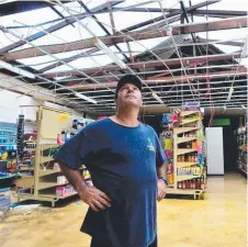  ?? GRIM SIGHT: Joey Basa surveys the damage at Collinsvil­le’s Foodworks store. Pictures: EVAN MORGAN ??