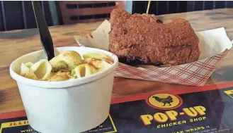  ?? CASSIDY WAIGAND/JOURNAL STAR ?? Customers can find Illinois Hot Chicken and Gouda mac and cheese at Pop-Up Chicken Shop in Bloomingto­n.