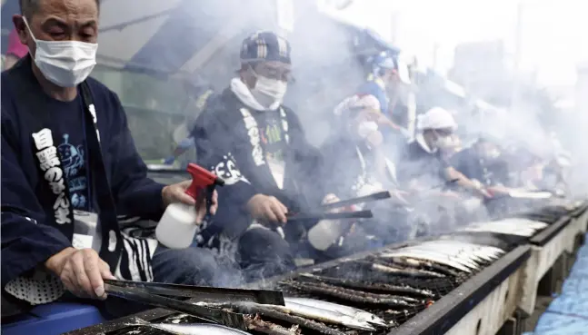  ?? Kota Kiriyama / The Yomiuri Shimbun ?? Pacific saury are grilled during the Meguro no Sanma Matsuri in Meguro Ward, Tokyo, on Sunday.