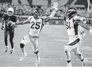  ?? [AP PHOTO] ?? Denver Broncos cornerback Chris Harris (25) high fives linebacker Todd Davis (51) as he scores a touchdown after an intercepti­on against the Arizona Cardinals on Thursday night in Glendale, Ariz.