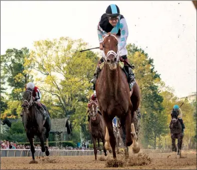  ?? Arkansas Democrat-Gazette/STEPHEN B. THORNTON ?? Jockey Joe Bravo brings 41-1 shot Danza (center) home to win the 78th running of the Arkansas Derby at Oaklawn Park in Hot Springs on Saturday. Ride On Curlin (left), ridden by Jon Court, finished second. The victory by Danza was the second consecutiv­e...