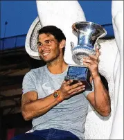  ?? DEAN MOUHTAROPO­ULOS / GETTY IMAGES ?? Spanish star Rafael Nadal, nearing his 32nd birthday, poses with the trophy after winning the Italian Open on May 20 in Rome.
