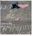  ?? AP ?? ‘EXEMPLARY DEDICATION’: Young boys left messages on chalk in April 2013 following the Boston Marathon bombing, where K9 Maura worked.